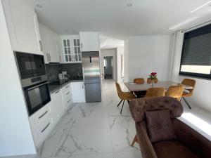 a kitchen and dining room with a table and chairs at Vila Softic Azra in Umag
