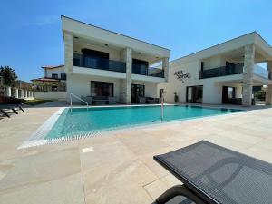 a swimming pool in front of a building at Vila Softic Azra in Umag