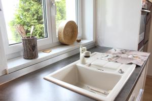 a white sink in a kitchen with a window at Kuh Heimat - Bergblick - Terrasse in Buchenberg +52 photos