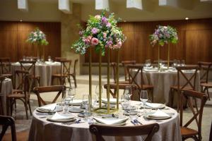 a table set up for a wedding with flowers at Melia Cozumel All Inclusive in Cozumel +74 photos