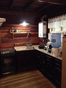 a kitchen with a sink and a counter top at Cabana dos Alpes in Canela