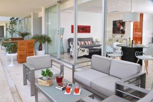 a living room with a couch and a table at Magia Beachside Condo in Playa del Carmen