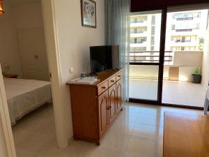 a bedroom with a bed and a television on a dresser at SERVICE APART LAZARO TOPACIO 3 in Calpe