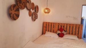 ein Schlafzimmer mit einem Bett mit einem Kopfteil aus Holz in der Unterkunft Bluesea Homestay in Phu Yen