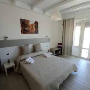 a bedroom with a bed with two towels on it at Red Moon in Cagliari