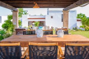 a wooden table and chairs on a patio at CAN FARITZEO in Sant Rafael de Sa Creu