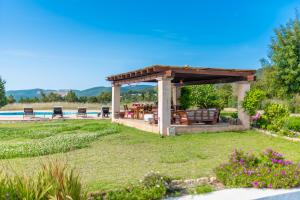 a gazebo with a table and chairs in a yard at CAN FARITZEO in Sant Rafael de Sa Creu