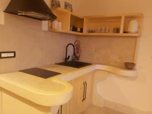 a kitchen with a sink and a counter top at 2022 RENOVATED apartment on the beach in Poljana