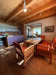 a kitchen and dining room with a wooden table and chairs at Schneider in Pāvilosta