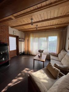 a living room with a couch and a table at Schneider in Pāvilosta
