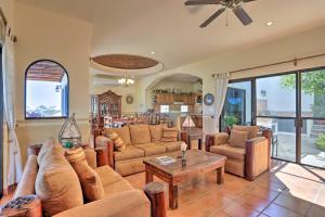 a living room with couches and a table at Lavish Cabo Resort Retreat with Pool Near the Beach! in Cabo San Lucas