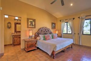 a bedroom with a large bed and a mirror at Lavish Cabo Resort Retreat with Pool Near the Beach! in Cabo San Lucas