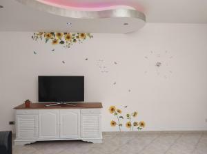 a living room with a tv on a white wall at Il Girasole del Centro Storico in Alcamo