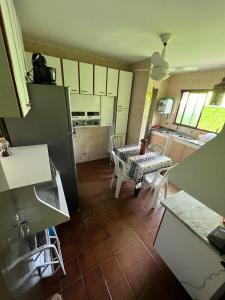 a kitchen with a table and a dining room at Hostel Raizer in Campo Grande