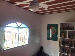 uma sala de estar com uma ventoinha de tecto e uma janela em Tabarka Lodge em Nova Friburgo
