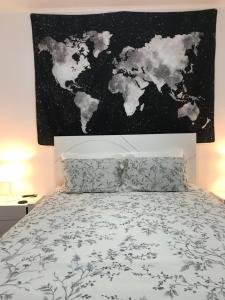 a bedroom with a bed with a map of the world at Sweet Home in Ponta Delgada