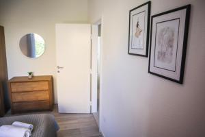a room with a hallway with a dresser and a mirror at Apartmani Nana Mija in Pag +104 photos