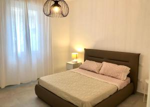 a bedroom with a bed with a large window at Le Nasse in Fano