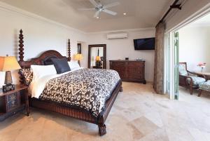 a bedroom with a bed and a couch and a chair at Sweet Dream Villa with Private Pool in Sugar Hill! in Saint James +17 photos