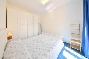 sypialnia z białym łóżkiem i niebieską podłogą w obiekcie A' casa 'e Carmeniello w mieście Ischia