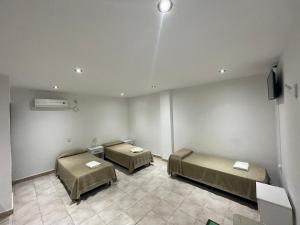 a hospital room with two beds and a tv at La Martinica in Villa Carlos Paz