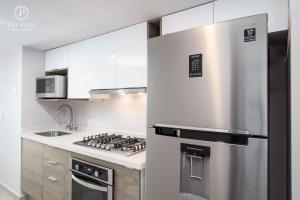 a kitchen with a stainless steel refrigerator and a stove at Harbor Puerto Vallarta 5009 in Puerto Vallarta