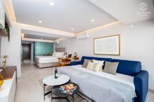 a living room with a blue bed and a table at Harbor Puerto Vallarta 5009 in Puerto Vallarta +40 photos