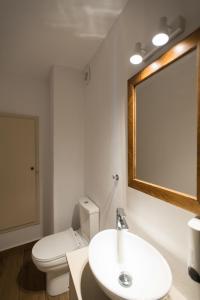 a bathroom with a toilet and a sink and a mirror at Myconian Old Town Maisonette THE MIMIs PLACE in Mýkonos City