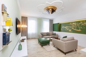 a living room with a couch and a table at Hotel Krone ****S in Tübingen