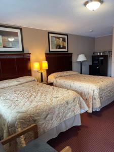 a hotel room with two beds in a room at Travel Inn in Horseheads