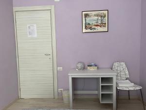 Cette chambre comprend un bureau, une porte et une table. dans l'établissement iride, à Bergame