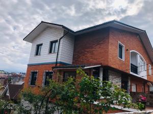 a large brick house on top of a hill at ROSALES Apartamento y jardín in Oviedo