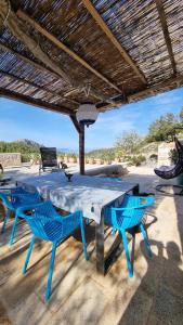 a table and two chairs under a wooden umbrella at Agave in Veliko Grablje