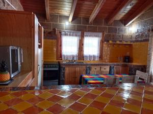 a kitchen with wooden cabinets and a counter top at Cabaña el piñon en Ezequiel Montes in Ezequiel Montes