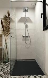 a bathroom with a shower with a glass door at Le Domaine de Pivette in Avranches