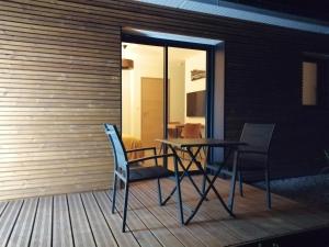 a table and two chairs on a deck at Le Domaine de Pivette in Avranches