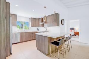 a kitchen with wooden cabinets and a white counter top at Palm Springs Modern Home Permit# 3972 in Palm Springs