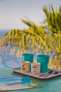 four cups sitting on a tray on a table at Mountain & Sea Villa in Kyra Panagia