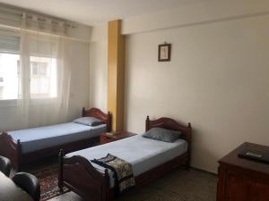 Säng eller sängar i ett rum på Familly Apartement Agdal Rabat centre