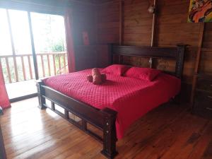 a teddy bear sitting on a bed in a room at Eco Granja Don Lolo in Quesada +84 photos