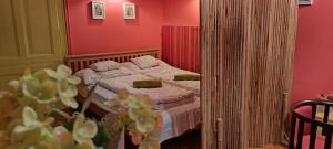 a bedroom with a bed with pink walls at Ráday Street Apartment Budapest in Budapest