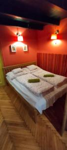 a large bed in a room with red walls at Ráday Street Apartment Budapest in Budapest