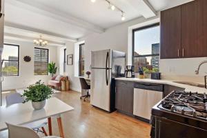 a kitchen with a stainless steel refrigerator and a table at 1BR Peaceful & Complete Apt with In-unit Laundry - Lake 303 in Chicago