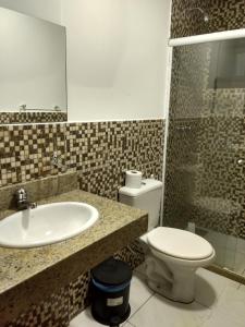 a bathroom with a sink and a toilet at Itacuruçá Inn in Itacuruçá