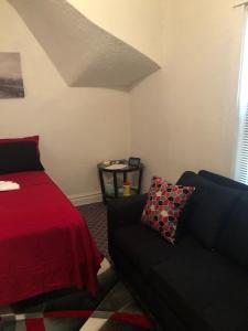 a living room with a bed and a couch at A Hidden Gem, approx 15 mins to downtown Chicago! in Chicago