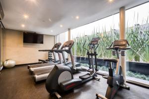 a gym with cardio machines and a large window at AR 218 by ULIV in Mexico City