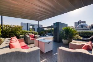 a rooftop patio with couches and tables on a building at AR 218 by ULIV in Mexico City