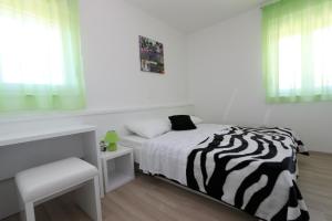 Postel nebo postele na pokoji v ubytování Villa Tamarut