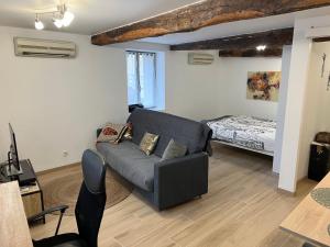 En eller flere senge i et værelse på Le loft de Saint-Gaudens - confort et central