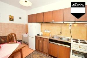 a small kitchen with a sink and a refrigerator at Apartment Jelka in Herceg-Novi